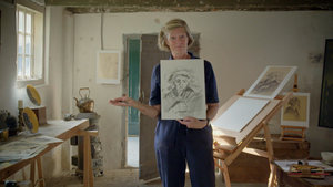 The workshop teacher shows her drawing of the face of a peasant woman