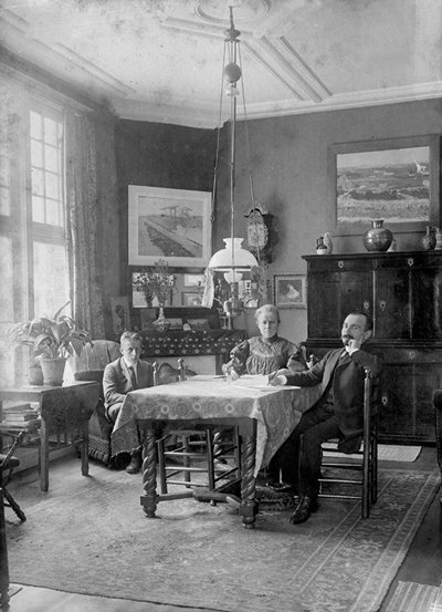 Photo of Jo Bonger in her living room, surrounded by paintings of Vincent